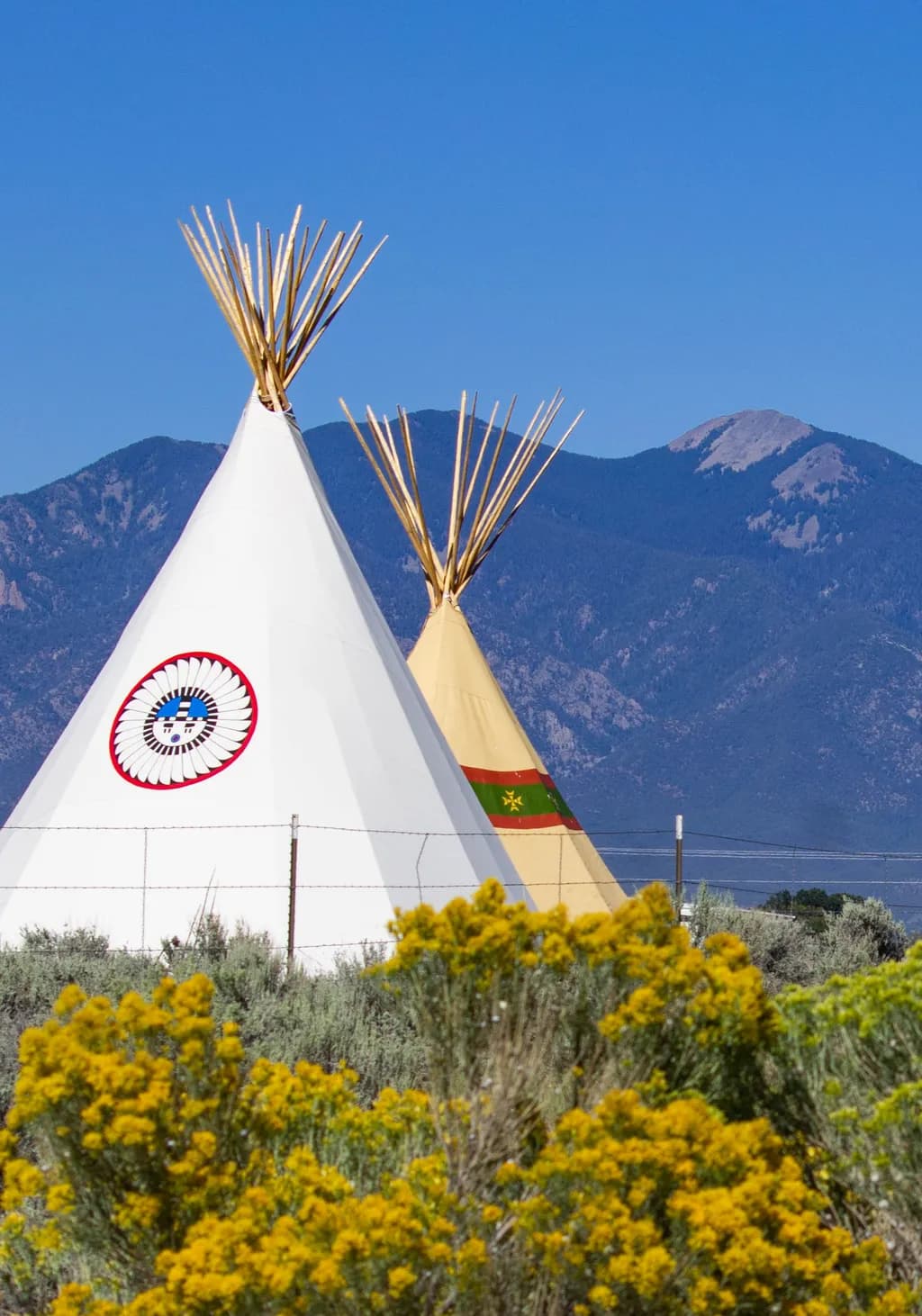 Whispers of Tradition: A Serene Landscape of Tipis Against Majestic Mountains