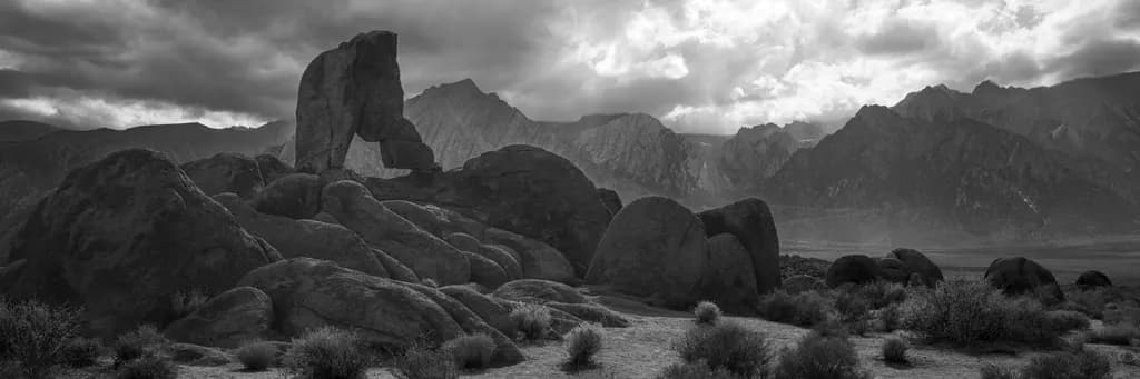 Whispers of Monochrome: A Dramatic Rocky Landscape Under Cloudy Skies