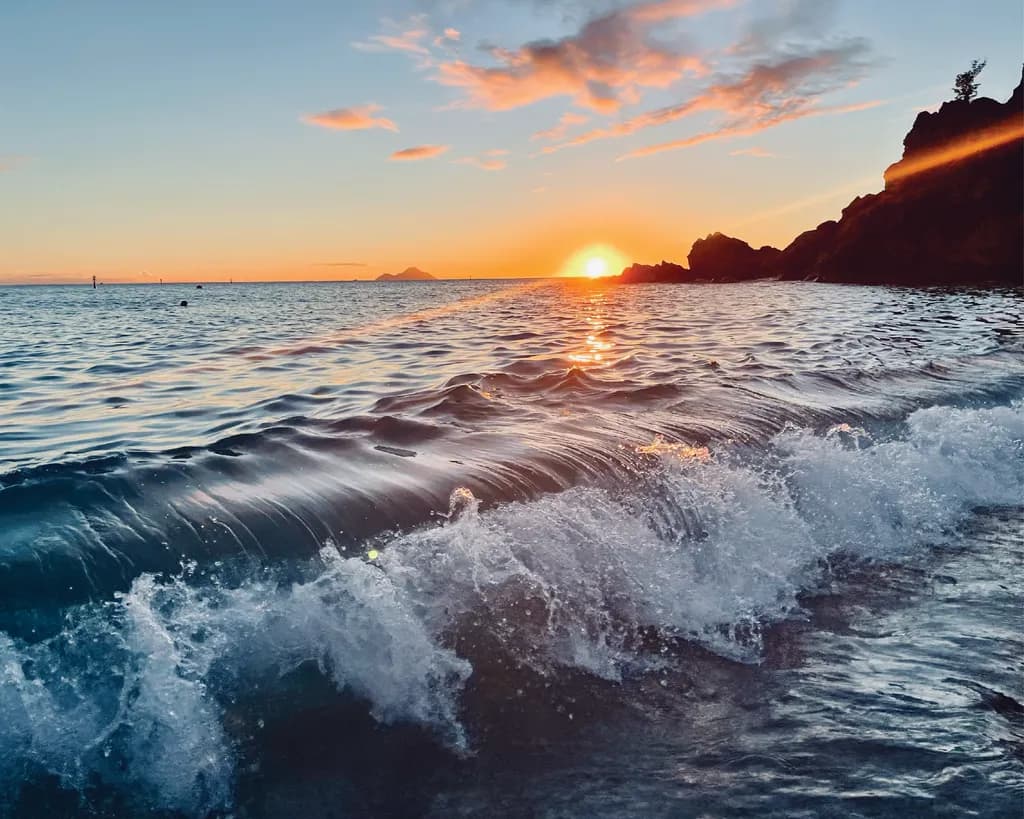 Serenity at Sunset: Waves Embracing the Dusk Horizon