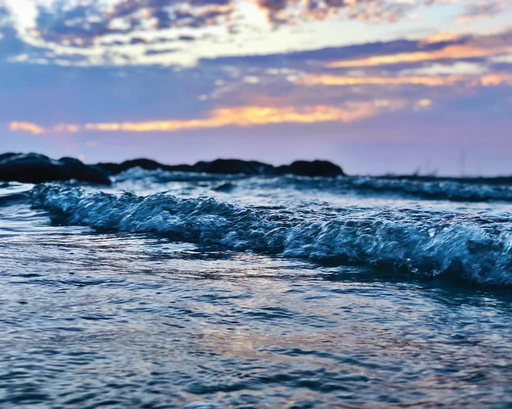 Whispers of the Ocean: A Serene Sunset Reflection Over Gentle Waves