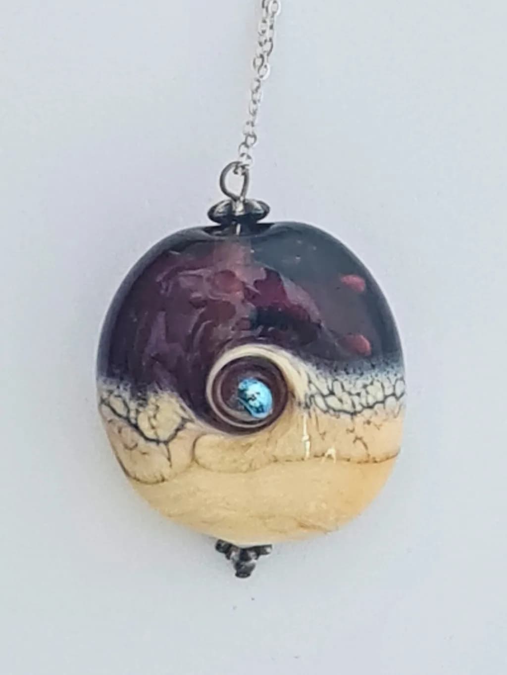Whimsical Oceanic Spiral: Handcrafted Pendant with Iridescent Detail