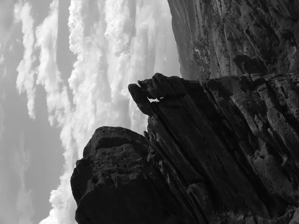 Dramatic Monochrome Landscape: Rugged Rocky Peaks Beneath Cloudy Skies