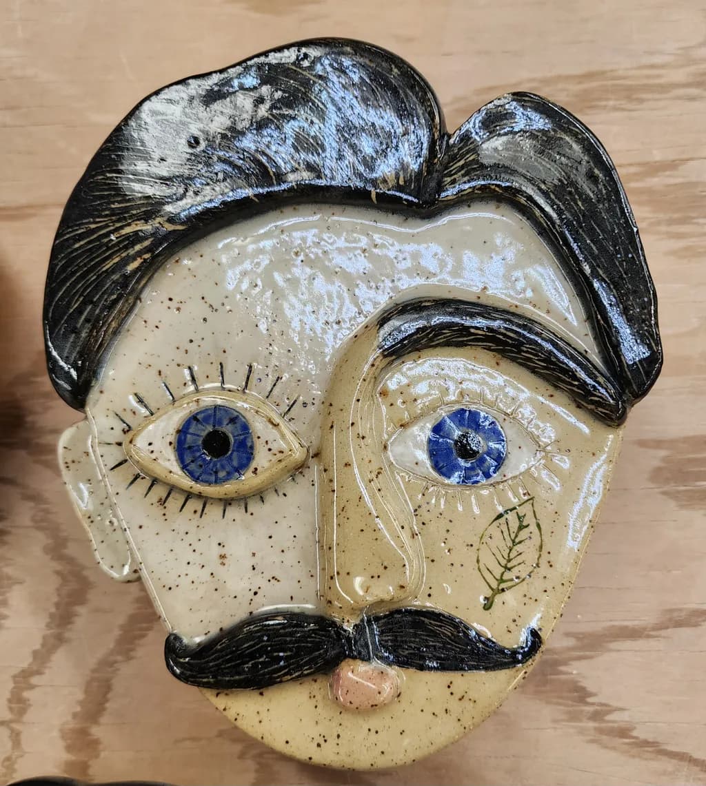 Whimsical Handcrafted Ceramic Face with Blue Eyes and Mustache