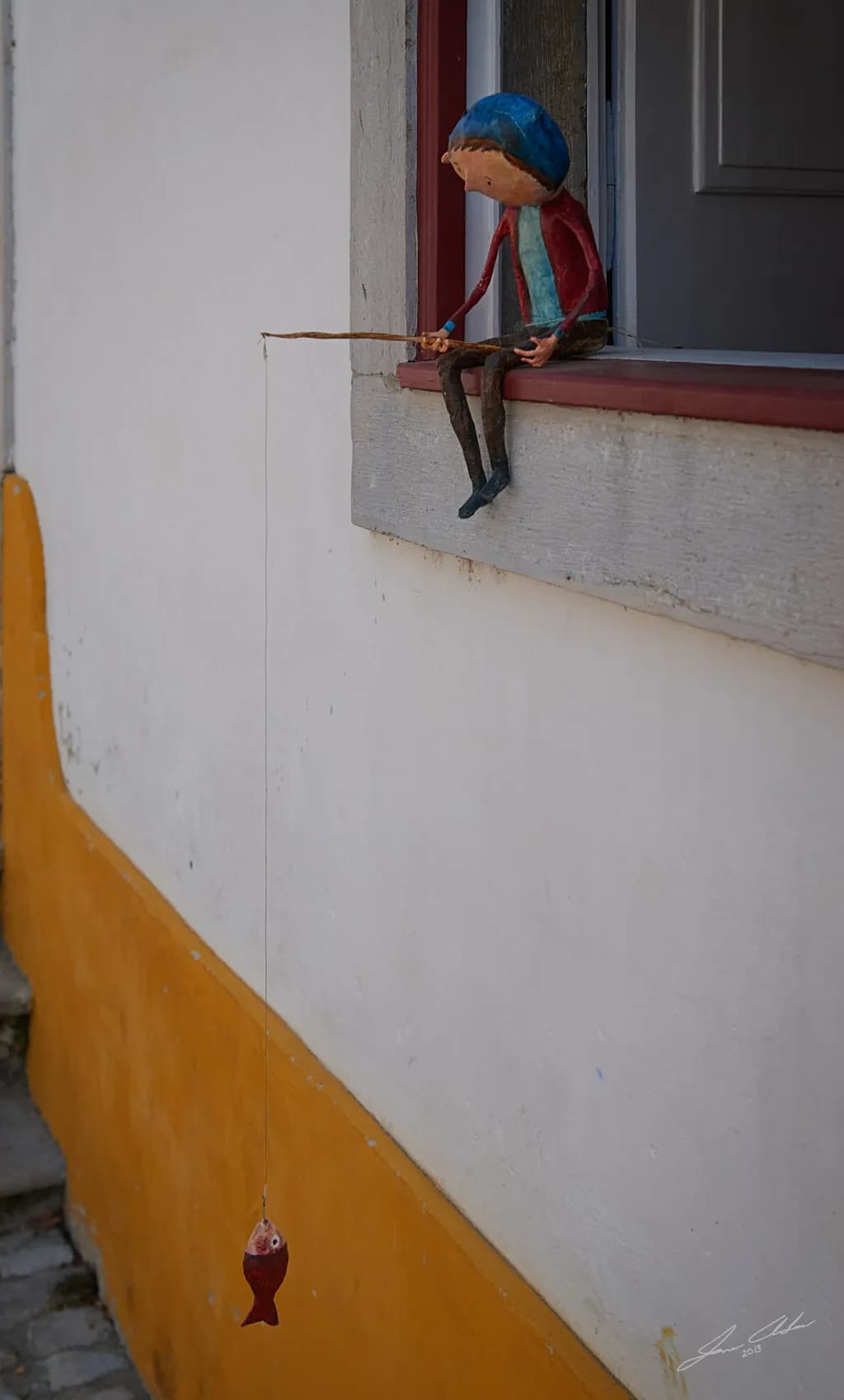 Fishing Figurine on Wall