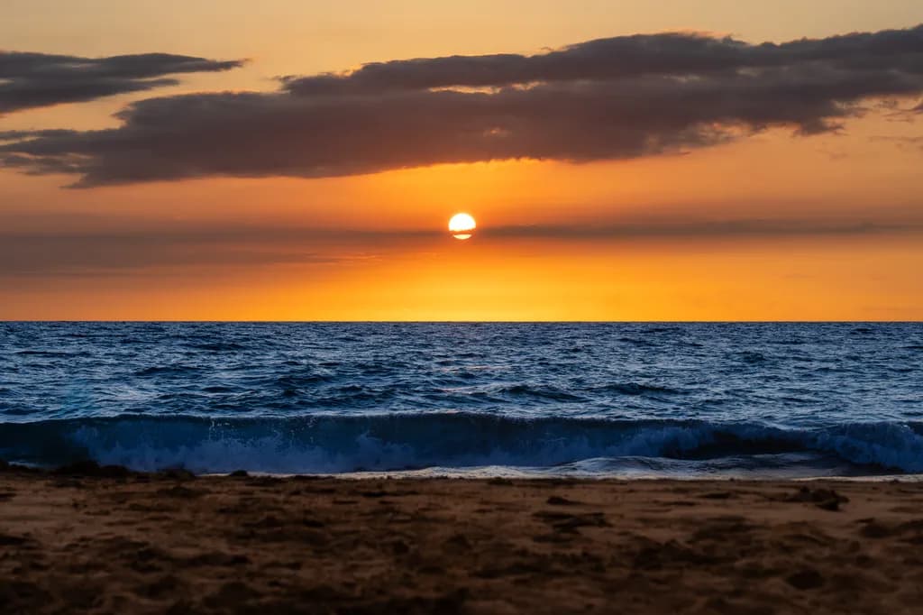 Serenity at Sunset: A Tranquil Beachscape of Sky and Sea