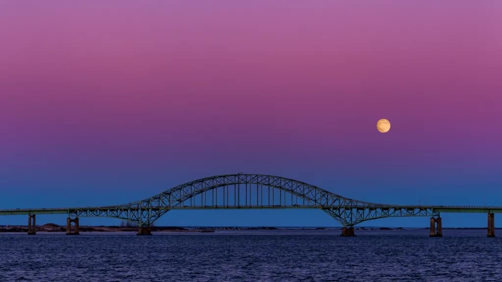 Moonlit Bridge: A Serene Evening Over Water