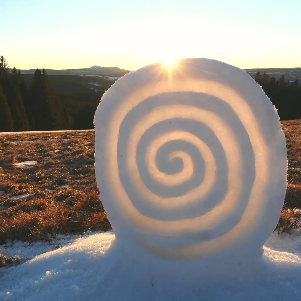 Whispers of Winter: A Spiraled Snow Sculpture at Dawn