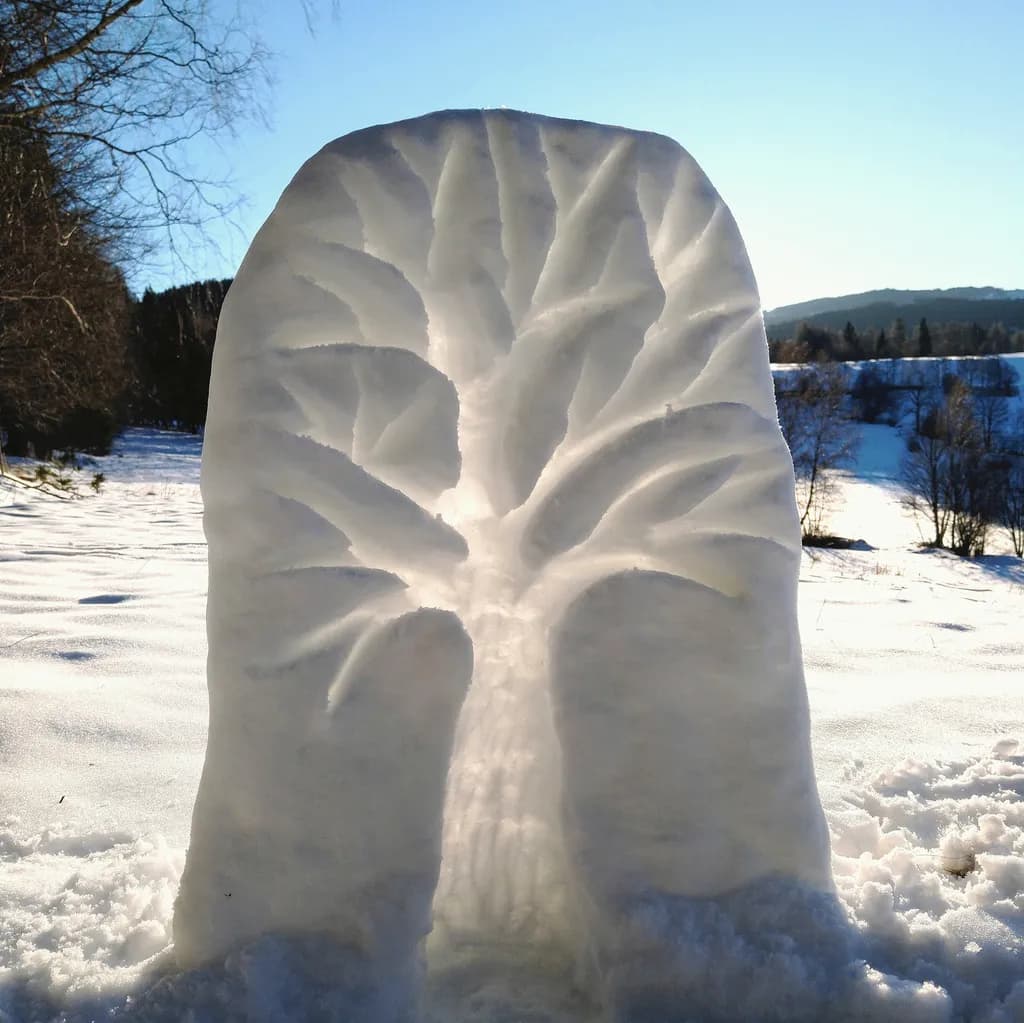 Whispers of Winter: A Snowy Tree Sculpture in Nature's Embrace