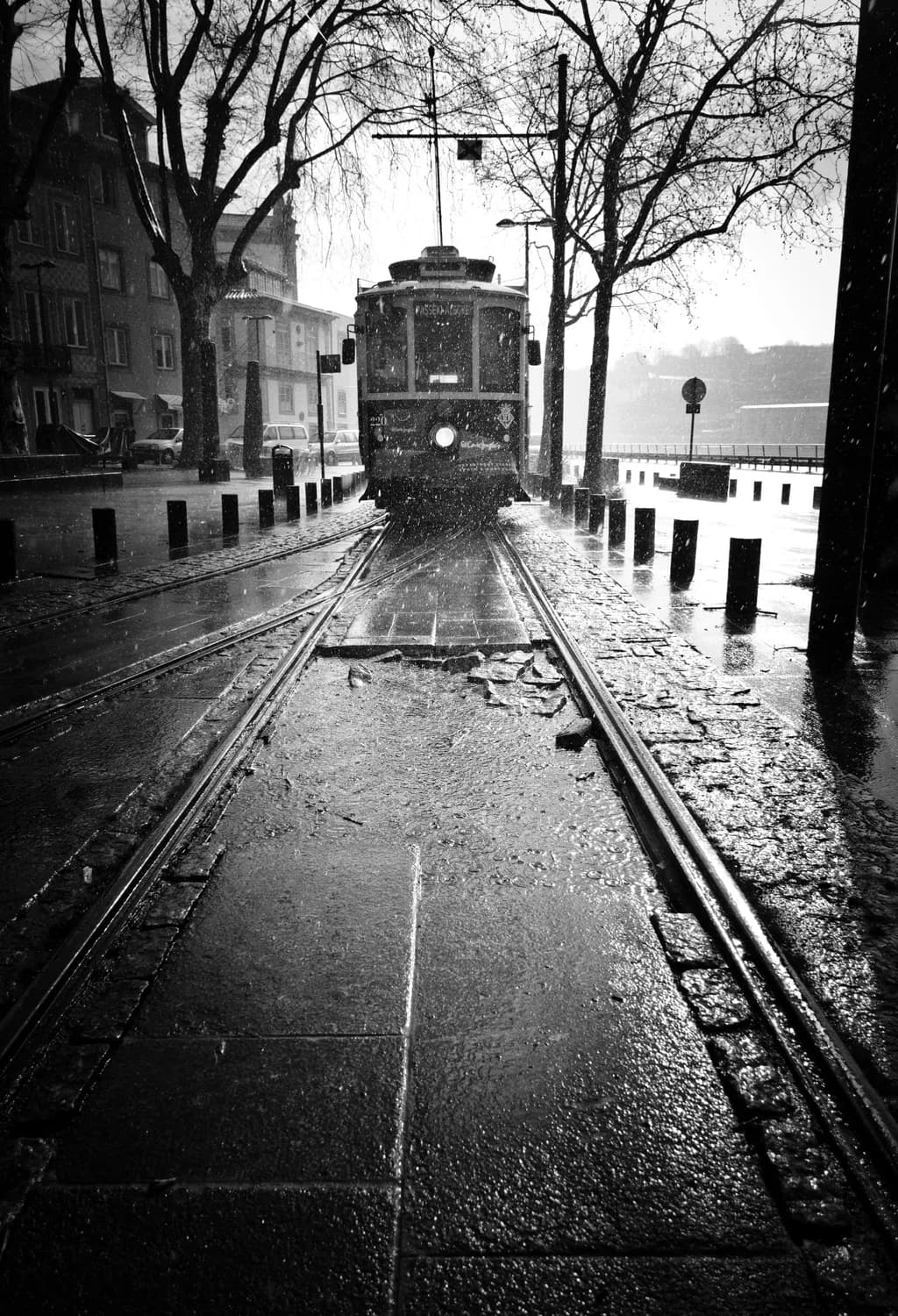 Whispers of Rain: A Tram's Journey Through a Glistening Cityscape