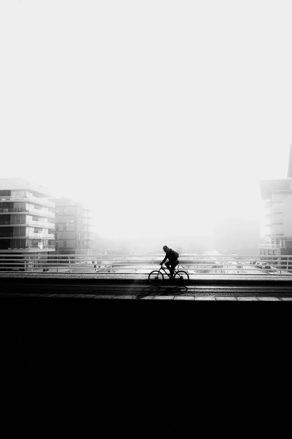 Silent Journey: A Cyclist's Path Through the Misty Urban Landscape