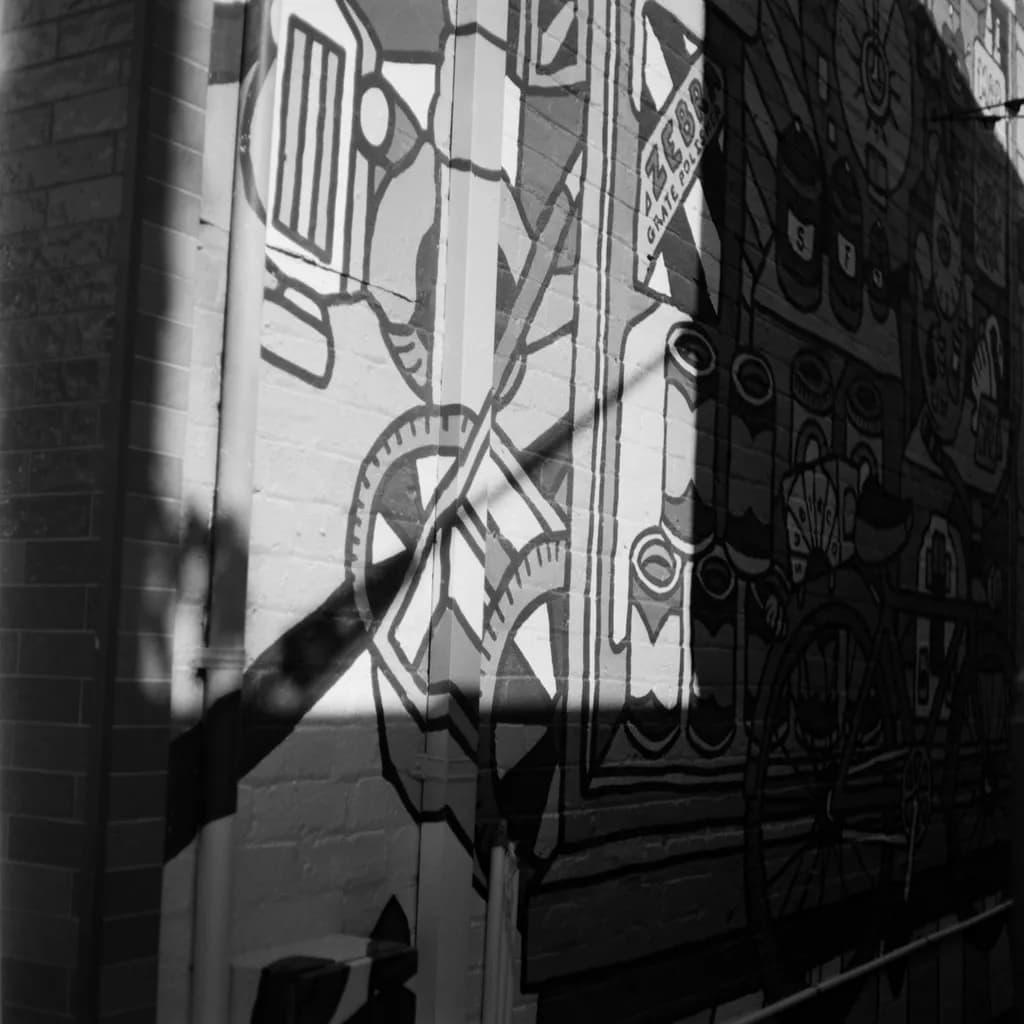 Urban Shadows: A Dance of Light and Form on the City Wall