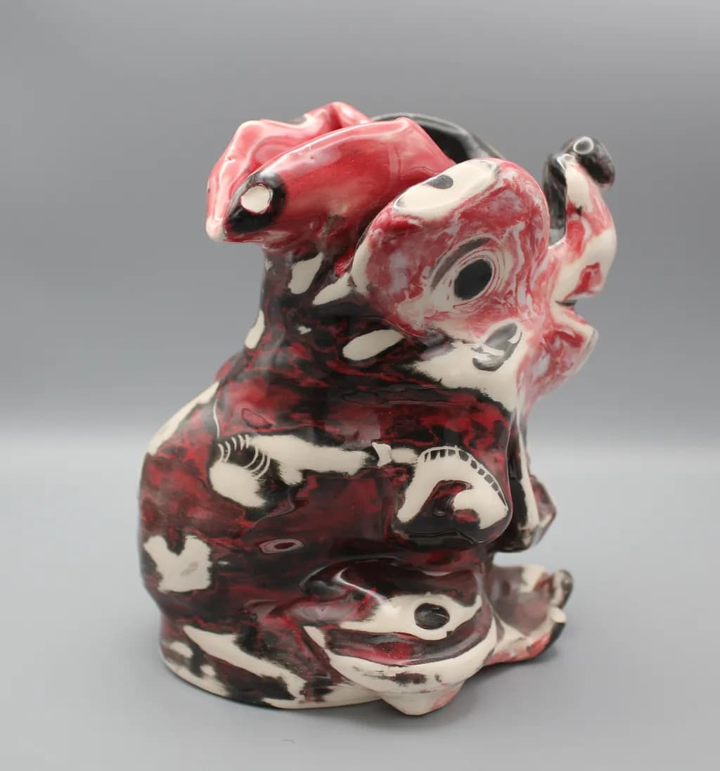 Whimsical Harmony: A Bold Red and Black Ceramic Sculpture