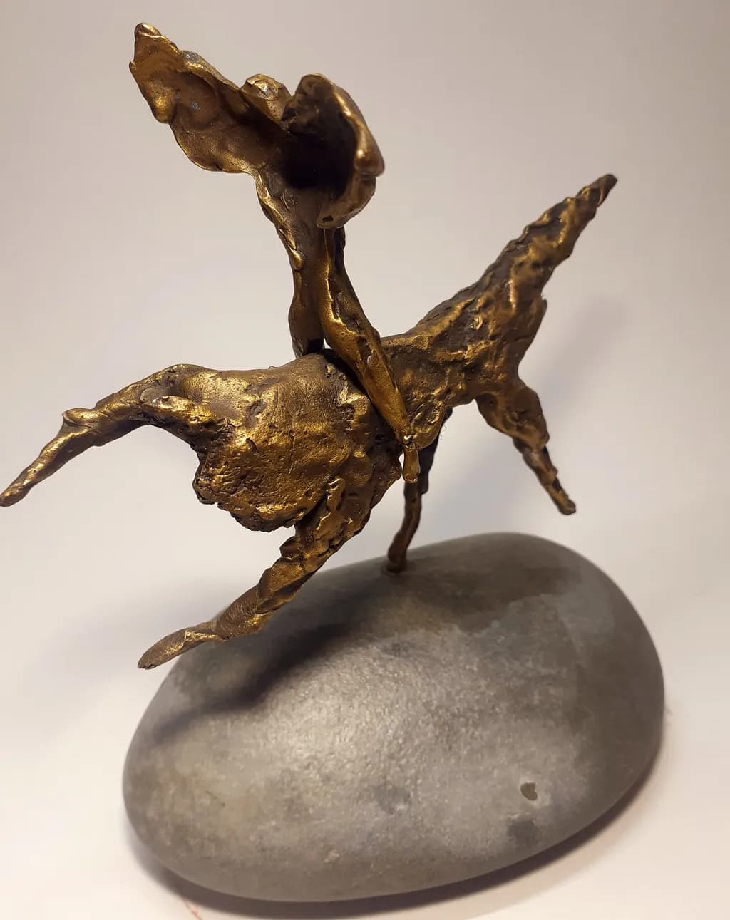 Ethereal Dance: A Bronze Figure on Stone, Capturing Movement and Emotion