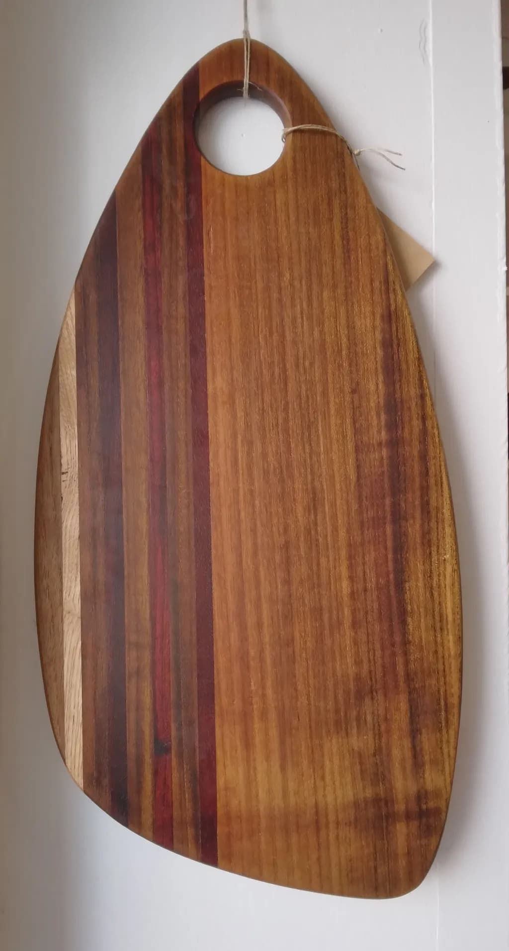 Elegant Artisan Cutting Board with Unique Grain Patterns and Handle