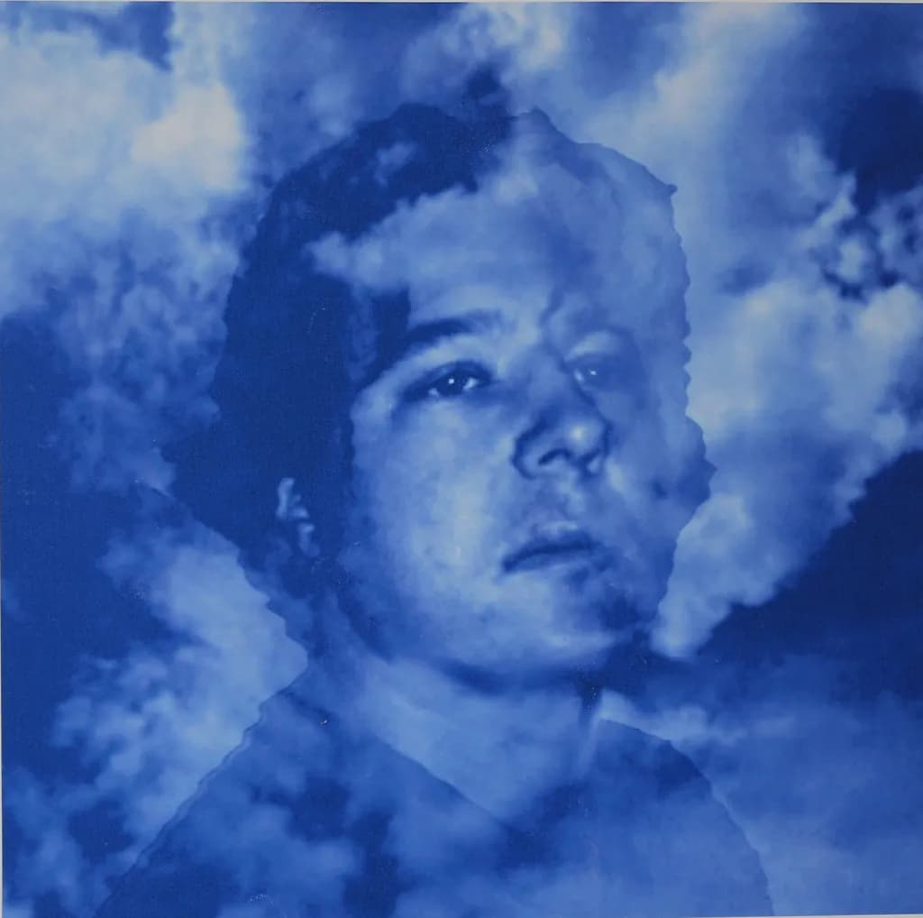 Ethereal Reflections: A Portrait in Blue Hues and Clouded Dreams