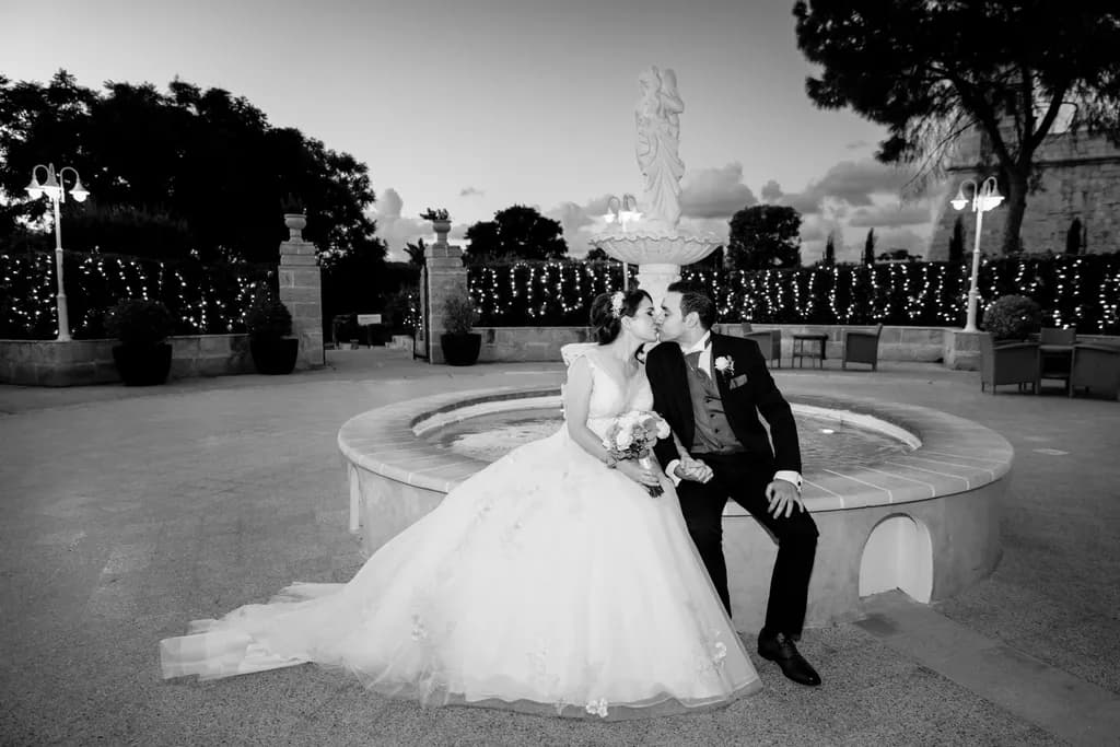 Eternal Embrace: A Romantic Wedding Kiss by the Fountain