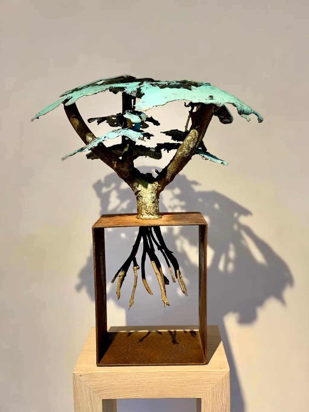 Whispers of Nature: A Bronze Tree Embracing Roots and Shadows