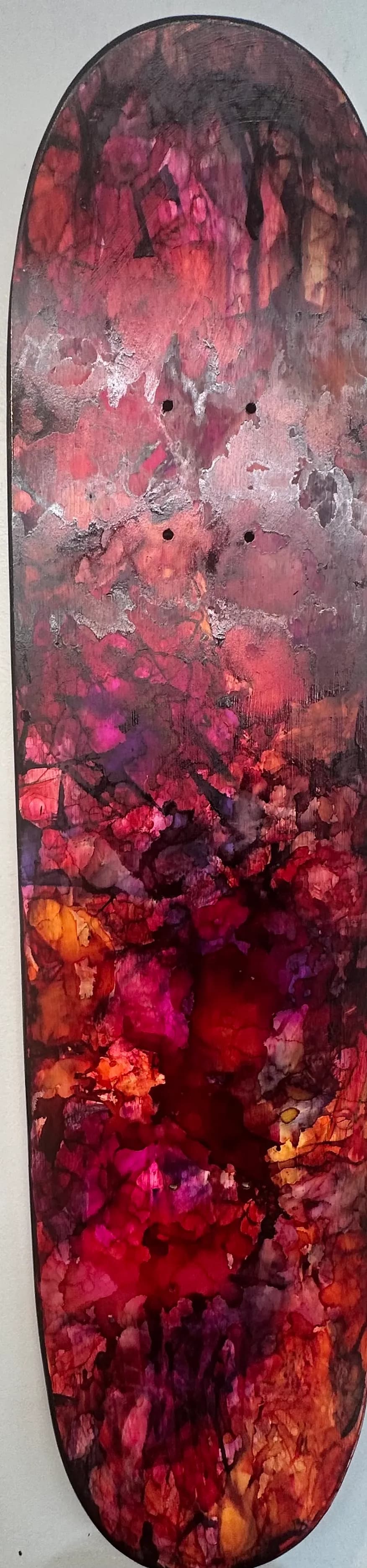 Vibrant Sunset: Abstract Skateboard Art in Rich Reds and Purples