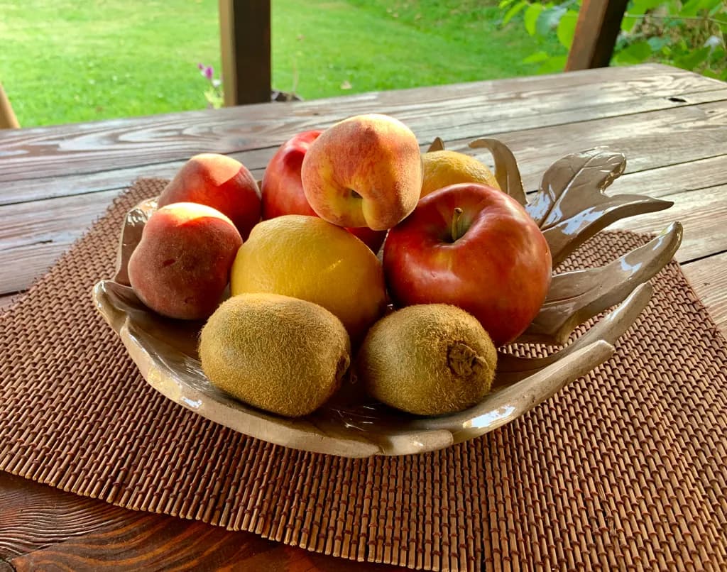Bountiful Harvest: A Relaxed Still Life of Fresh Fruits in Nature's Embrace