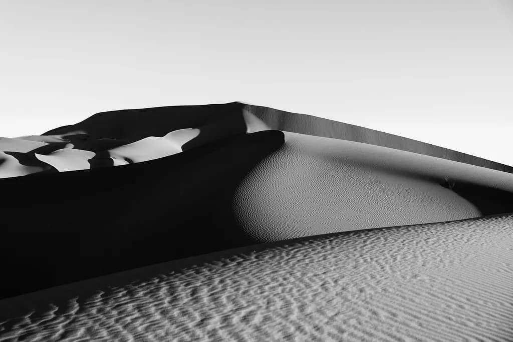 Whispers of the Desert: A Monochrome Dance of Sand Dunes