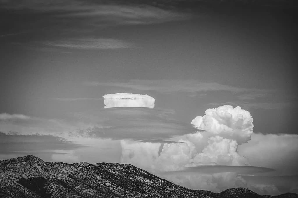 Ethereal Horizons: A Dance of Clouds Over Majestic Mountains