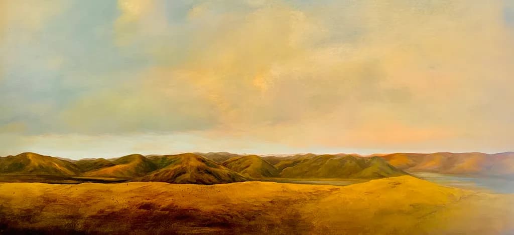 Golden Horizons: A Serene Landscape of Rolling Hills and Soft Skies