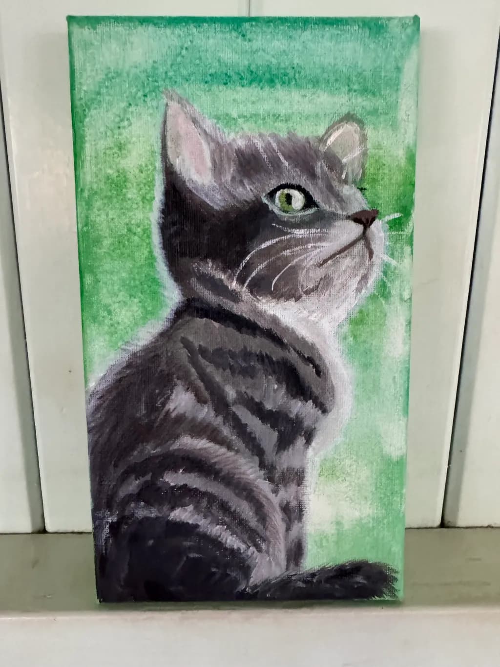 Whiskered Serenity: A Striking Portrait of a Cat in Lush Green Hues