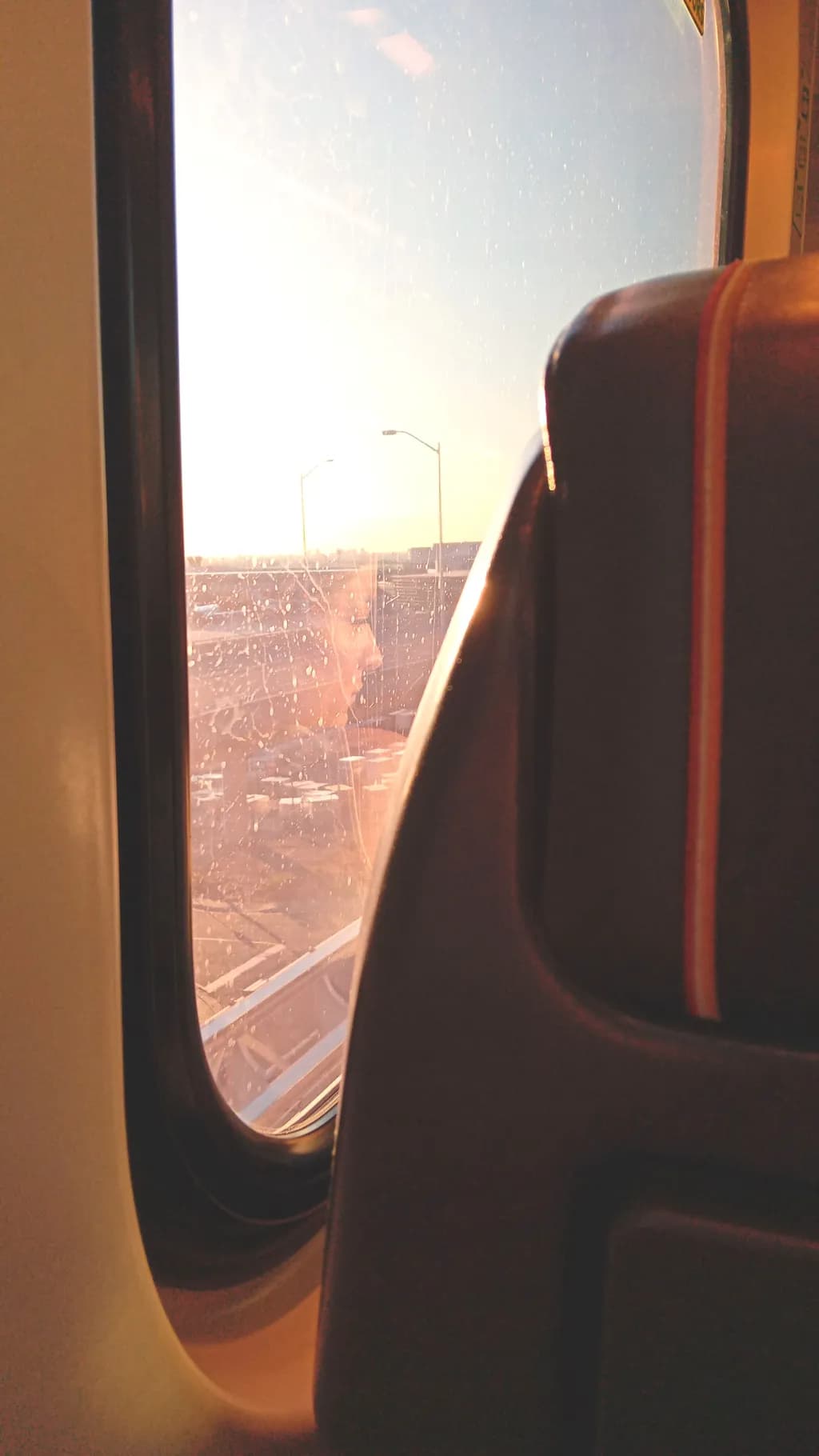 Reflections of a Journey: A Glimpse Through the Train Window at Sunset