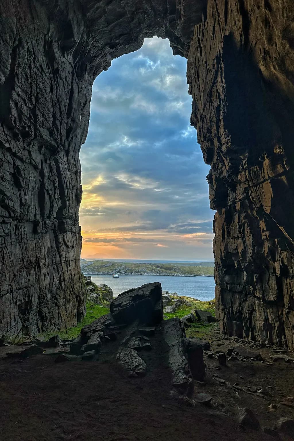 Cave's Embrace: A Serene View of Sky and Sea at Dusk