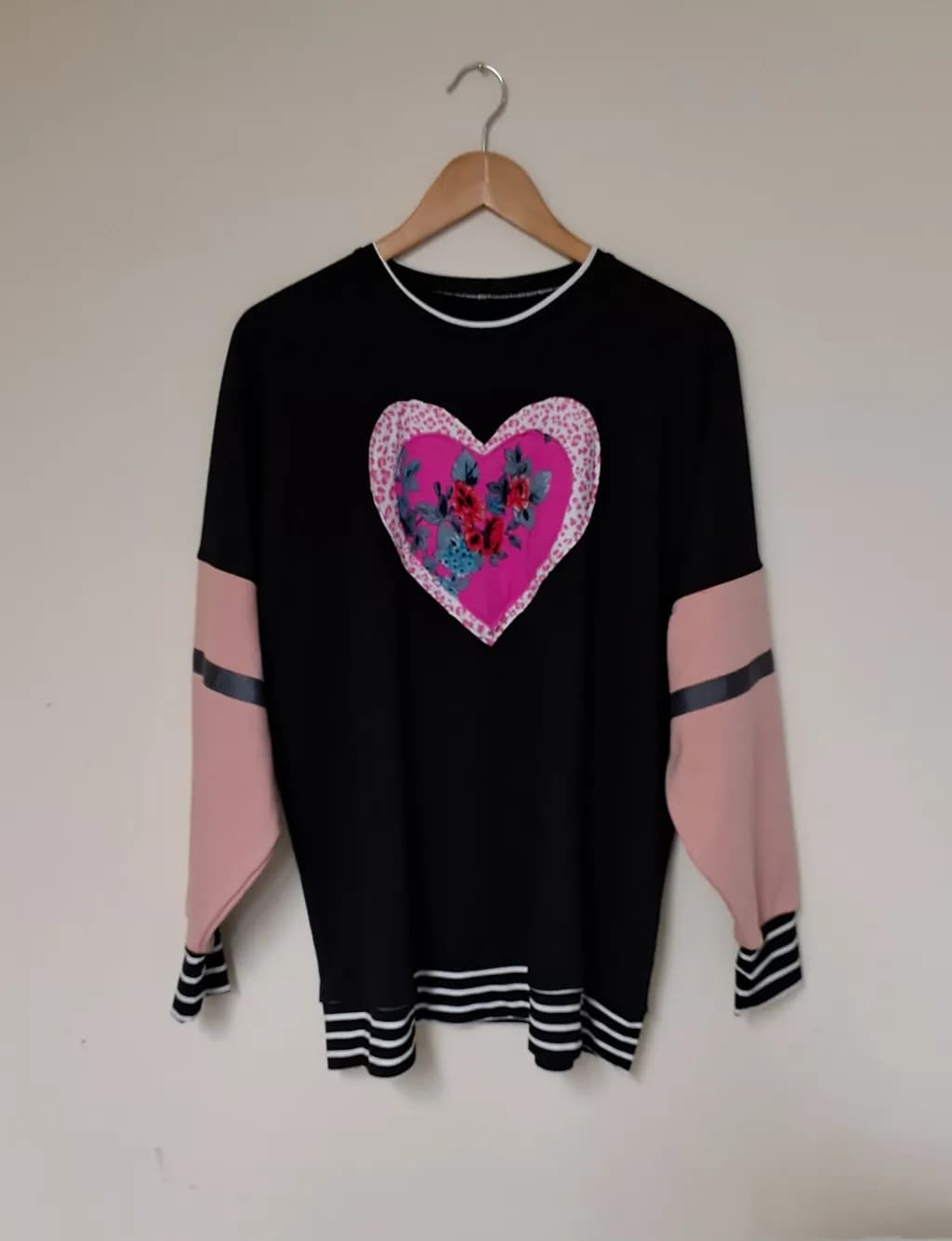Heartfelt Elegance: Floral-Embellished Black Sweater with Chic Color Block Design