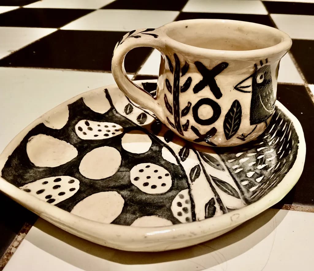 Whimsical Black and White Ceramic Cup and Plate Set with Playful Patterns and Nature Motifs