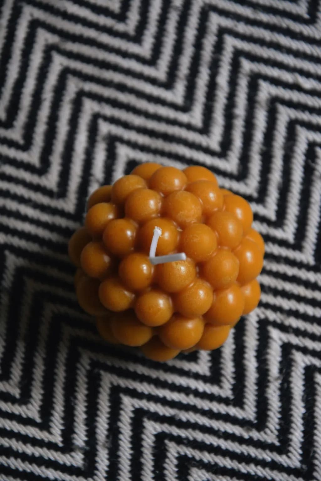Golden Sphere Candle: A Textured Delight for Cozy Ambiance