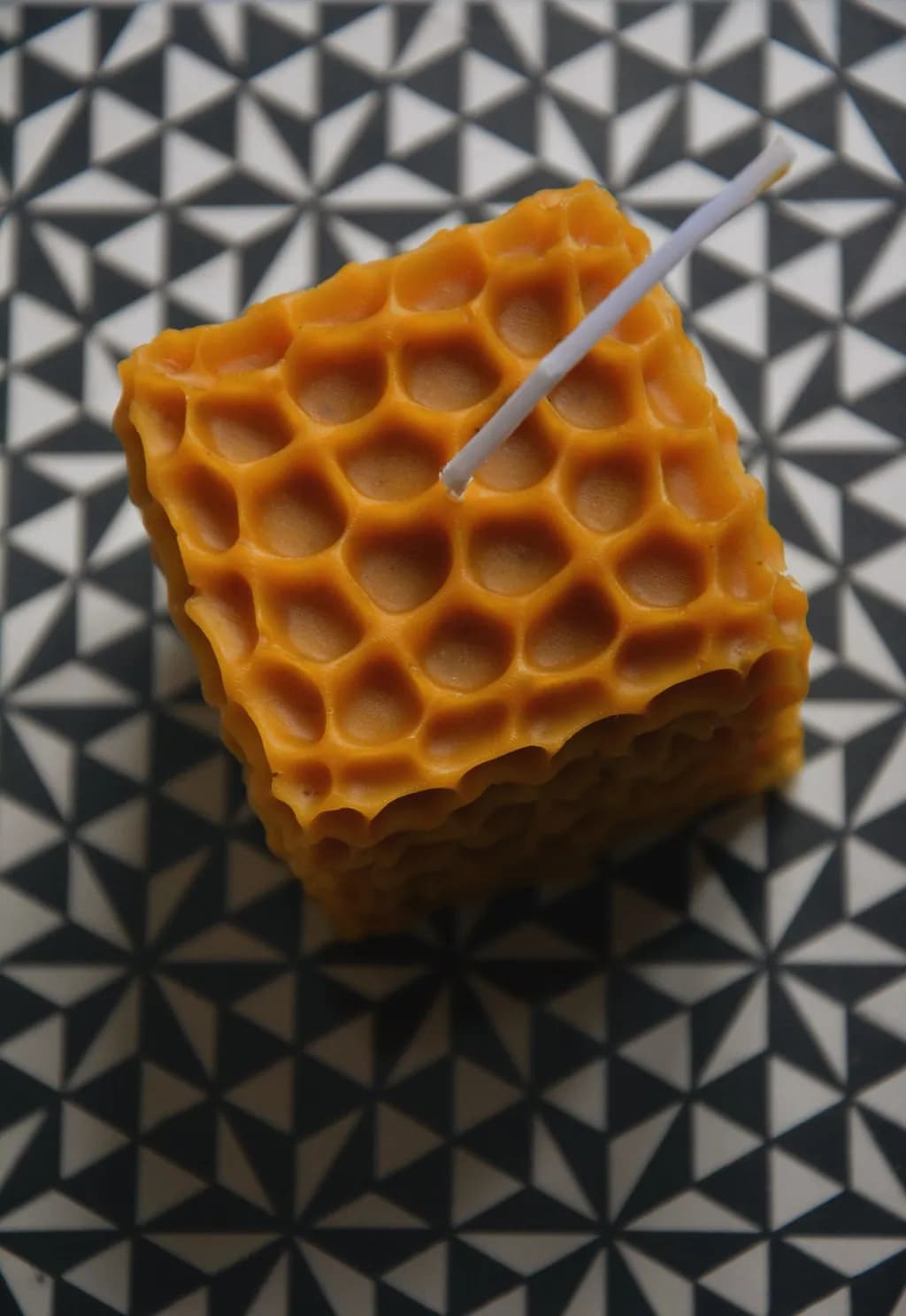Honeycomb Harmony: A Geometric Candle in Vibrant Orange Texture
