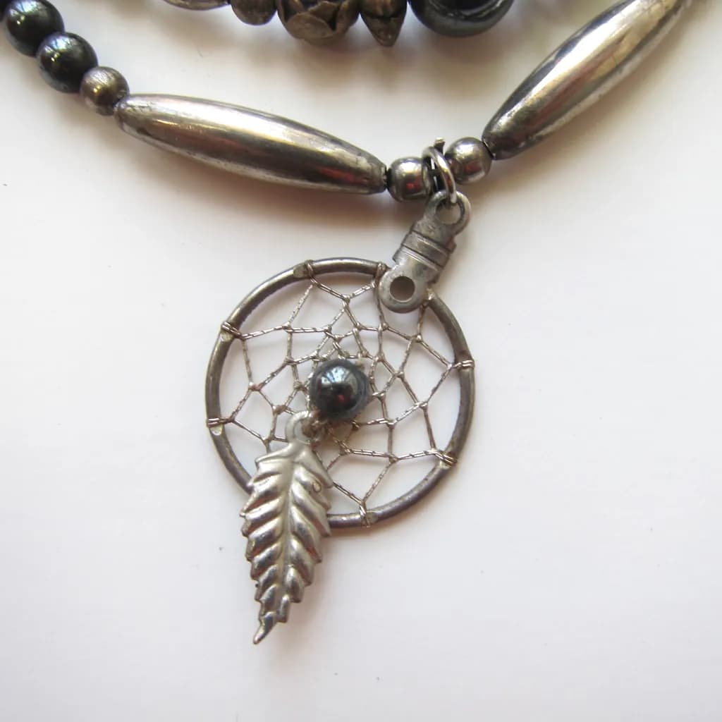 Dreamcatcher Elegance: A Silver Leaf and Hematite Charm Necklace for Spiritual Connection and Style