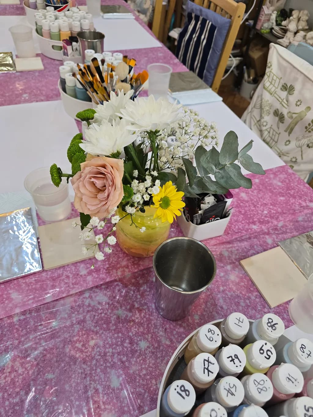 Creative Haven: A Colorful Gathering of Art Supplies and Blooms