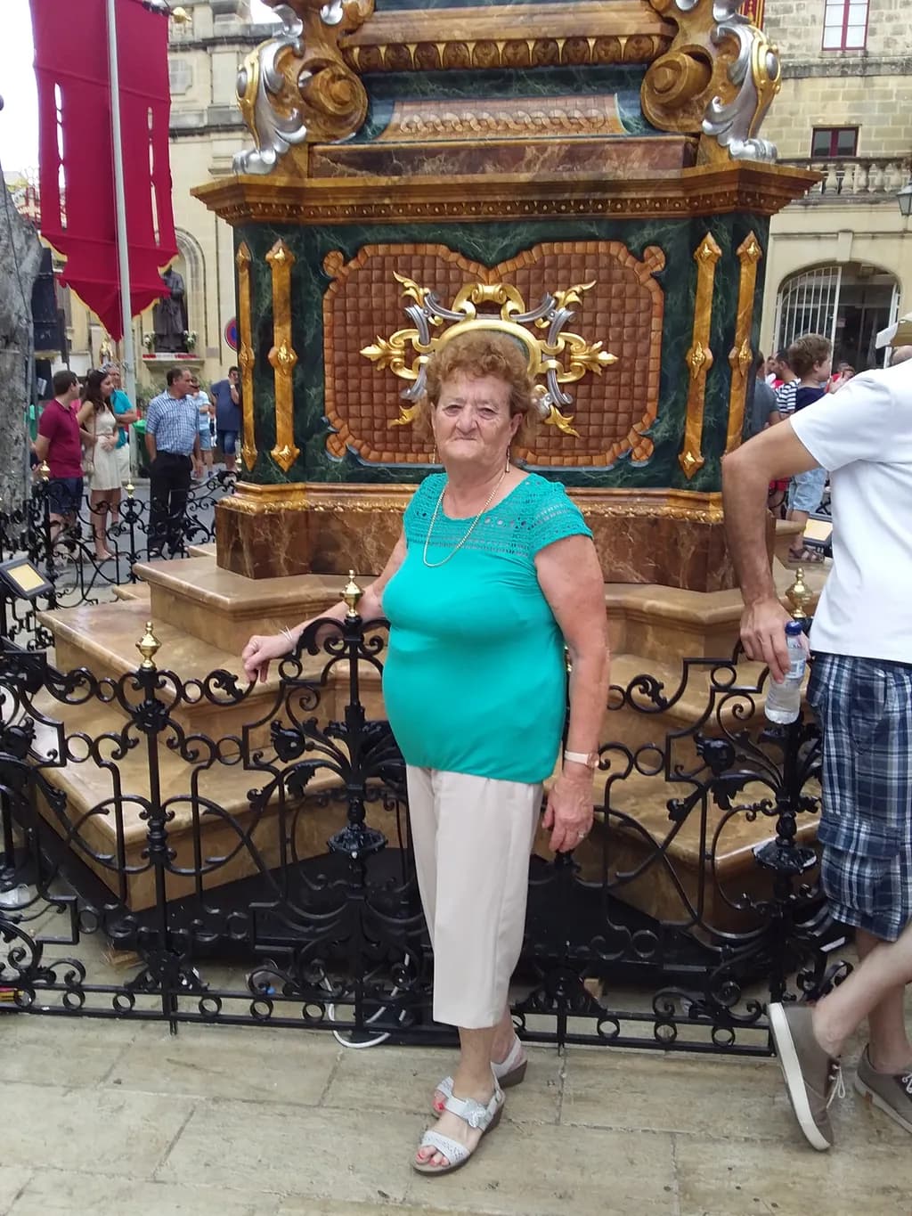 Elderly Grace: A Moment of Reflection Amidst Vibrant Surroundings
