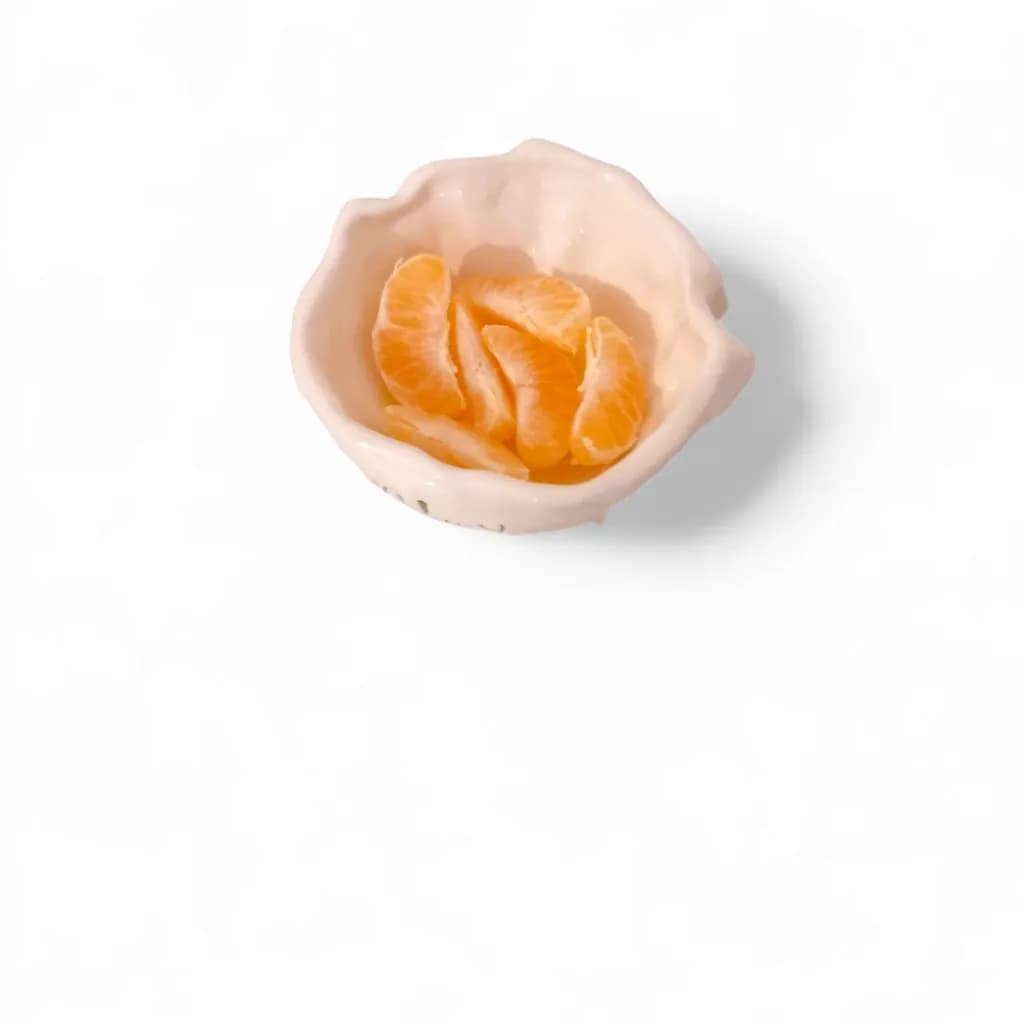 Citrus Serenity: A Delicate Harmony of Orange Segments in a Handcrafted Bowl