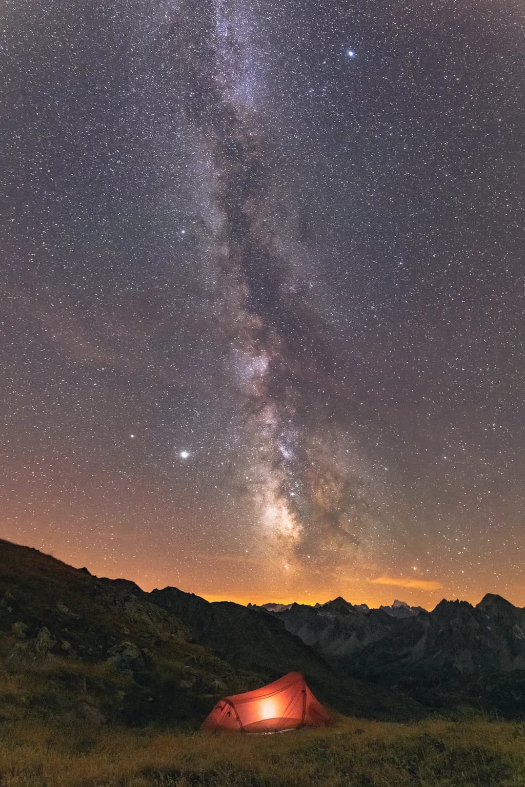 Whispers of the Cosmos: A Serene Night Under the Stars with a Glowing Tent
