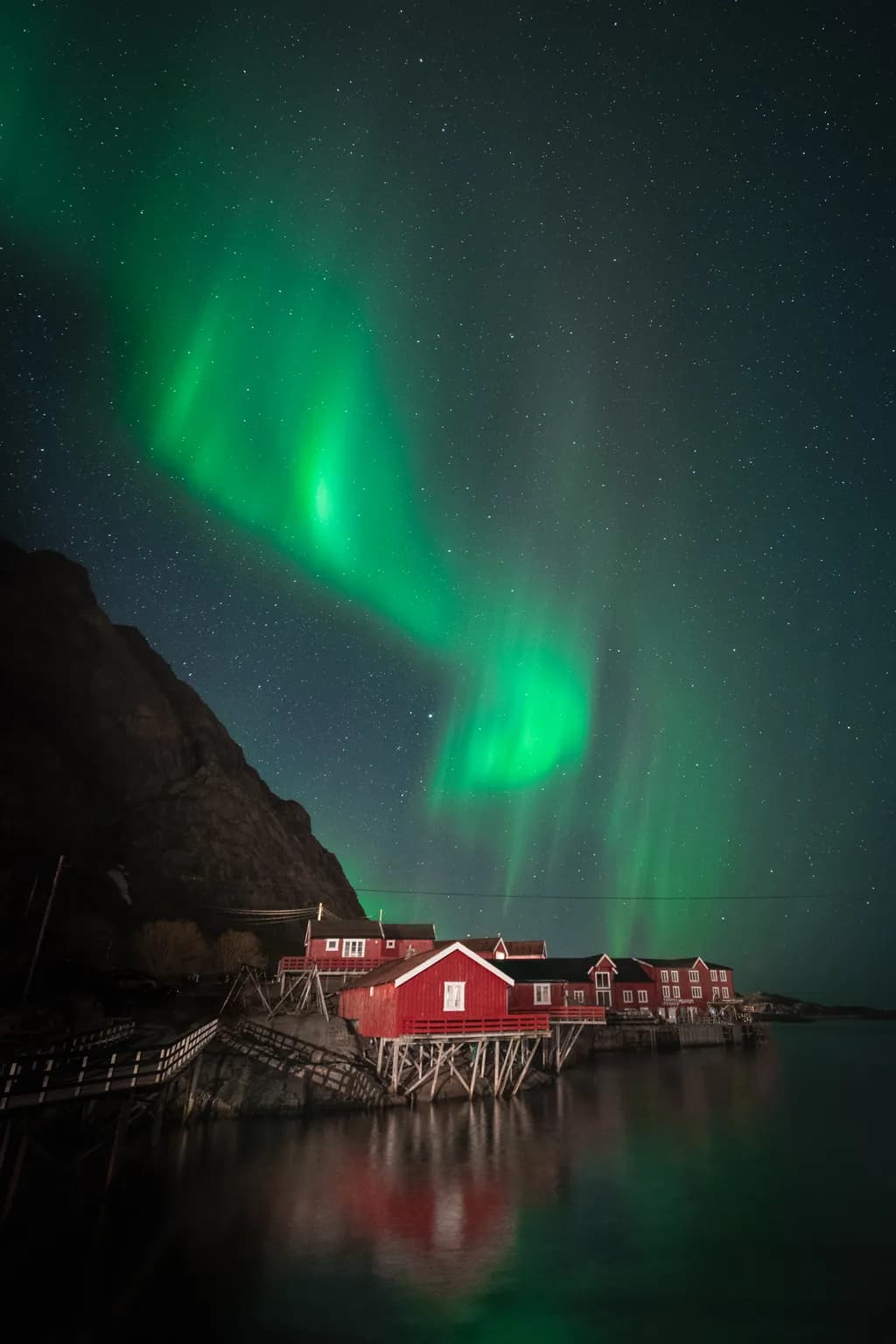 Whispers of the Aurora: Enchanted Red Cabins Under the Northern Lights