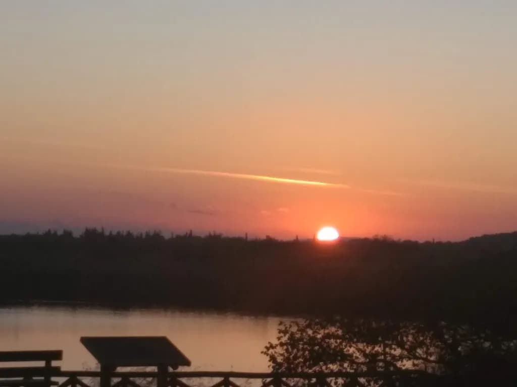 Serenity at Dusk: A Tranquil Sunset Over Still Waters