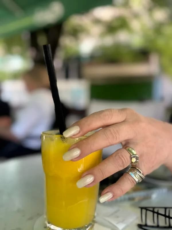 Refreshing Elegance: A Stylish Hand Embracing a Citrus Delight