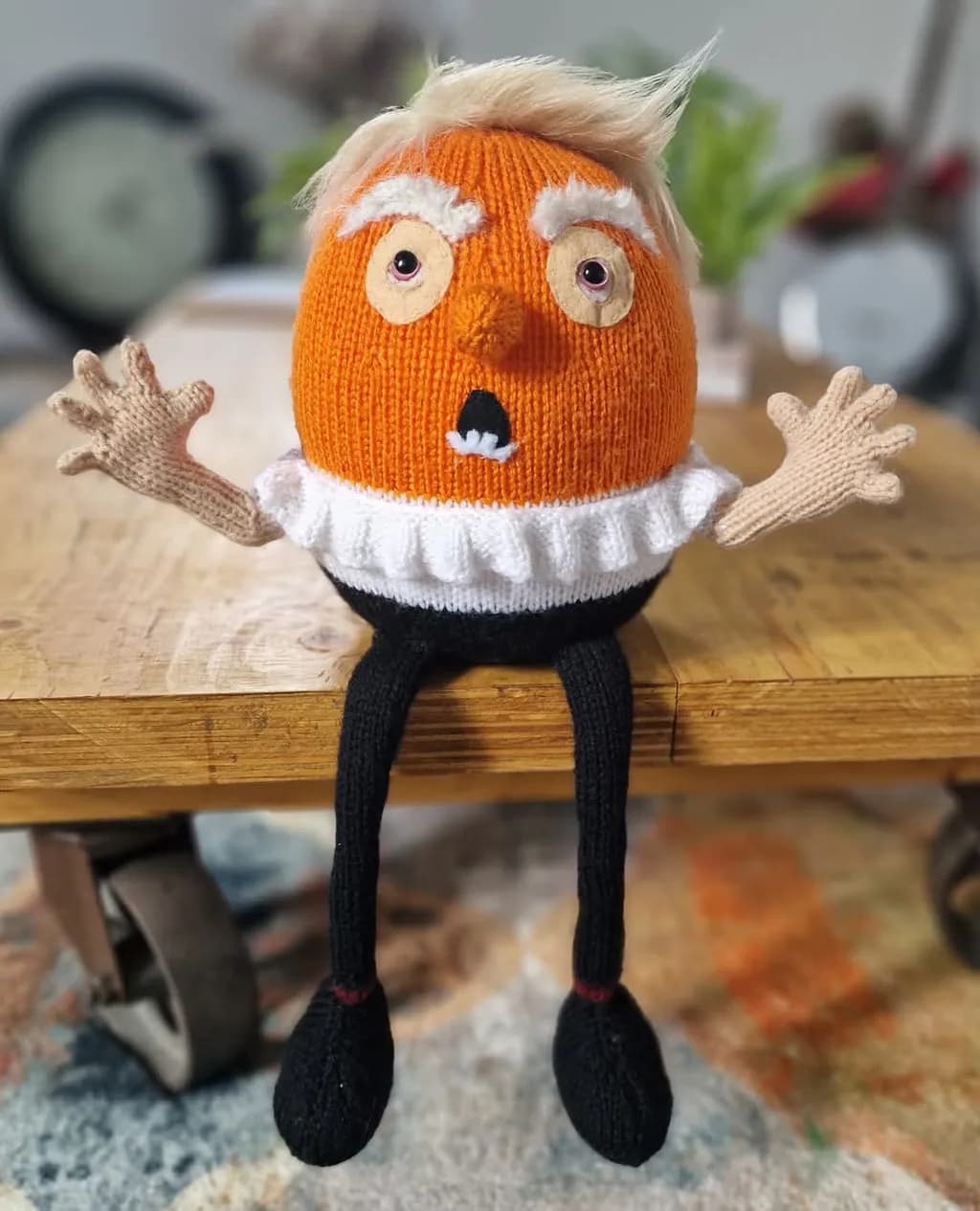 Whimsical Orange Egg Character with Surprised Expression and Knitted Details