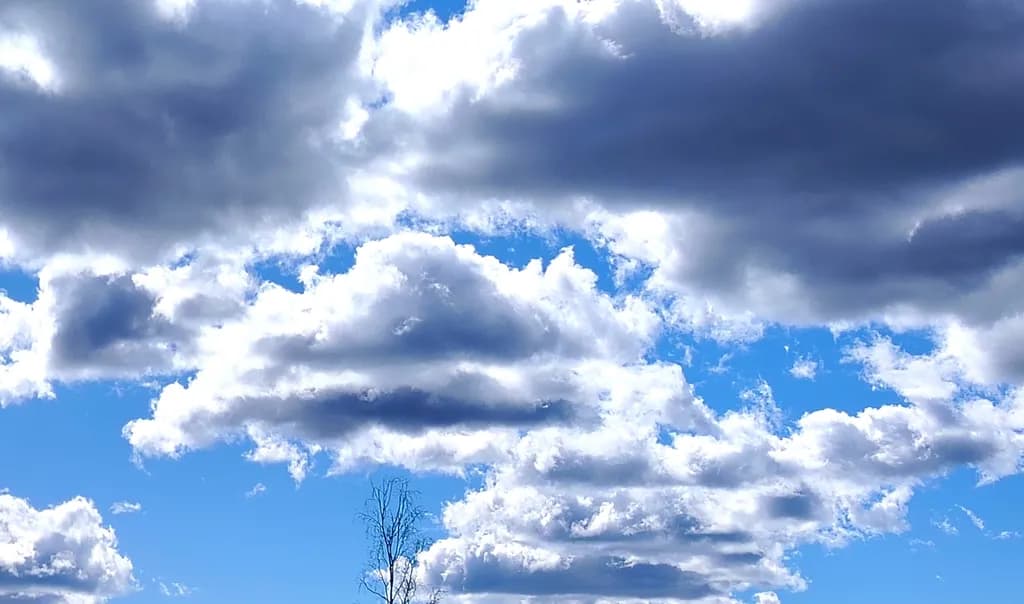 Whispers of the Sky: A Dance of Clouds and Blue Serenity