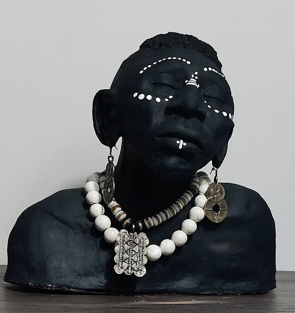 Ethereal Elegance: A Black Clay Bust Adorned with Cultural Jewelry