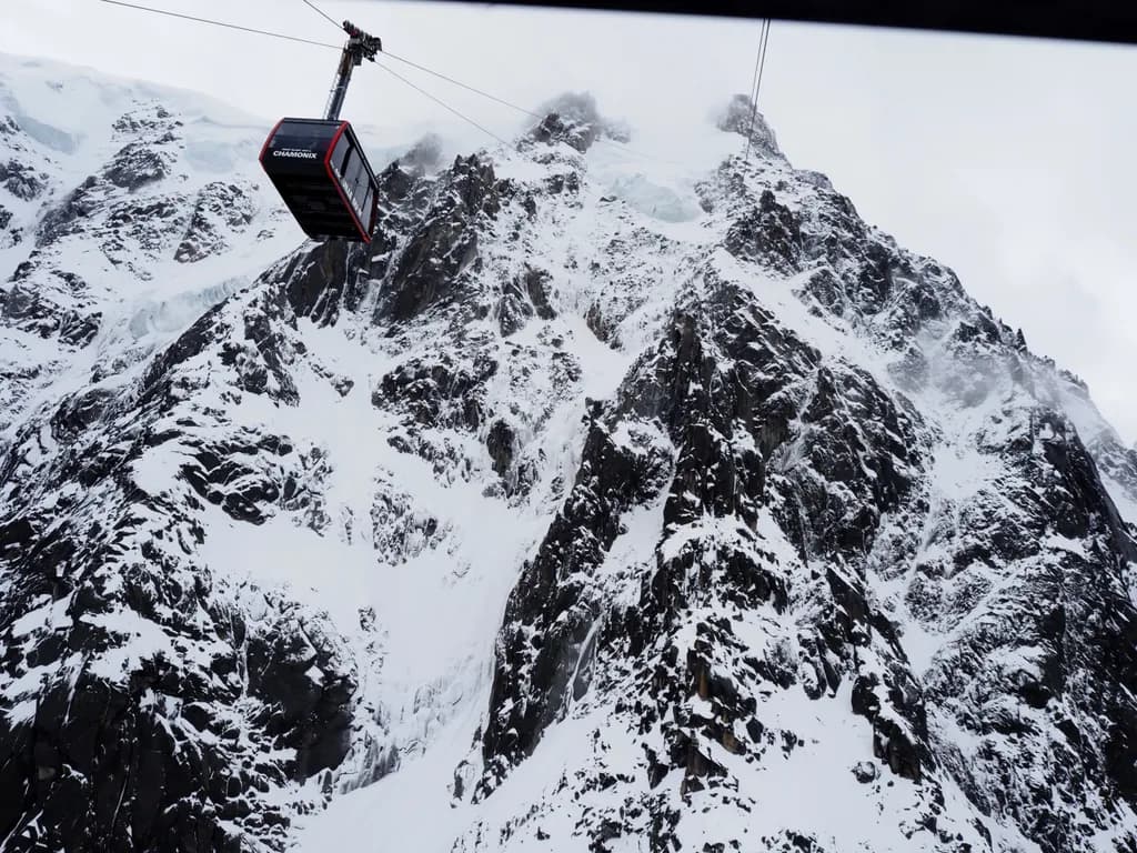Majestic Ascent: A Gondola's Journey Through Snow-Capped Peaks