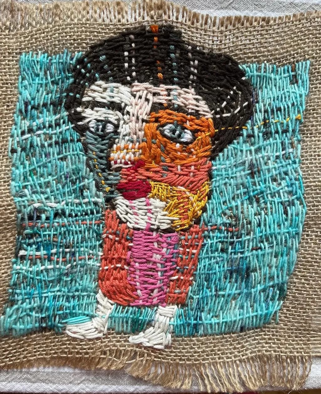Whimsical Threads: A Vibrant Embroidery Portrait of Emotion and Color