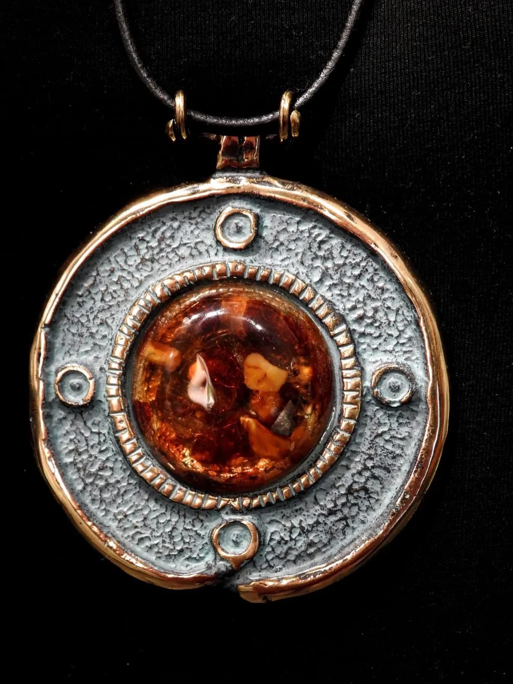 Amber Embrace: A Unique Artisan Pendant with Textured Silver and Gold Accents
