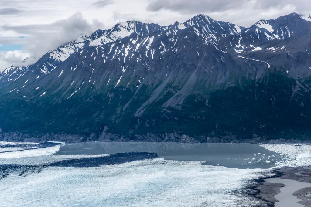 Majestic Glacial Serenity: A Panoramic View of Snow-Capped Peaks and Ice Fields