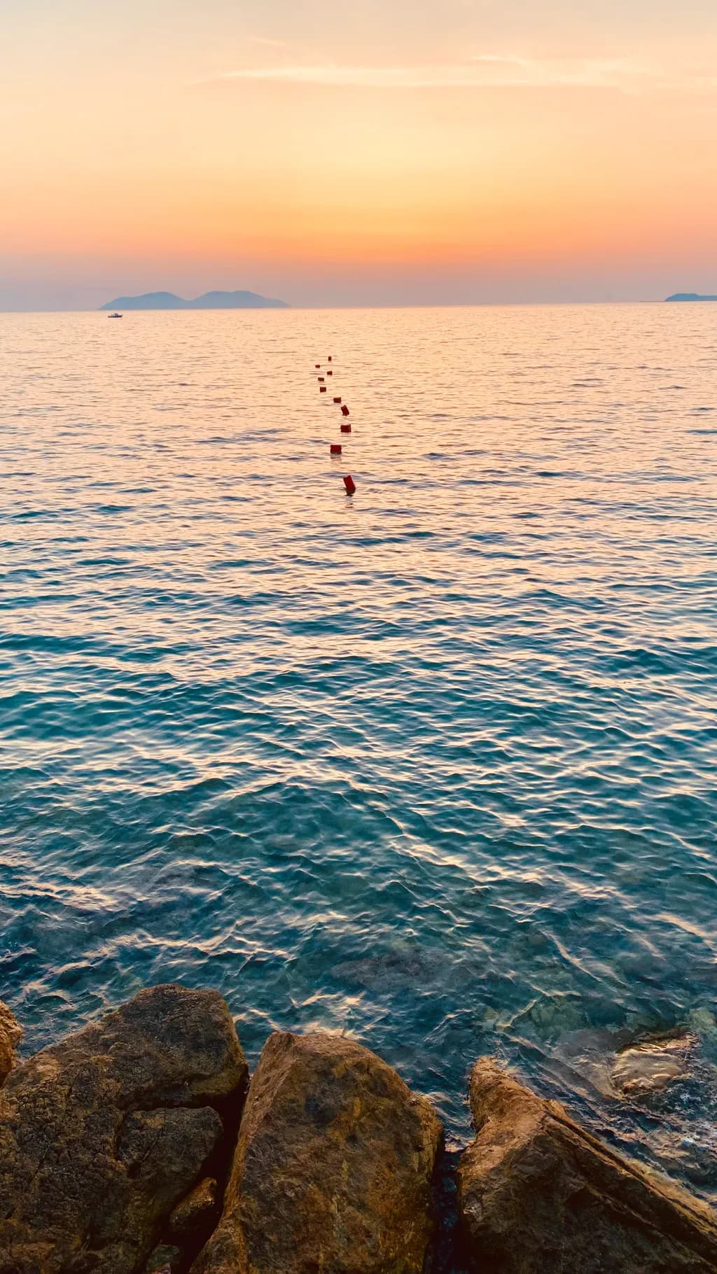 Serenity at Dusk: A Tranquil Seascape with Gentle Waves and Distant Isles