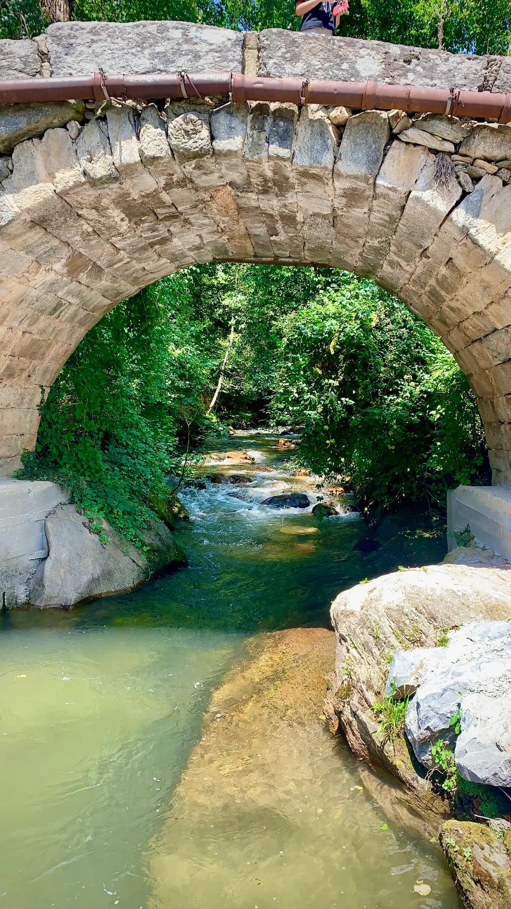 Whispers of Nature: A Serene Stone Bridge Over Tranquil Waters